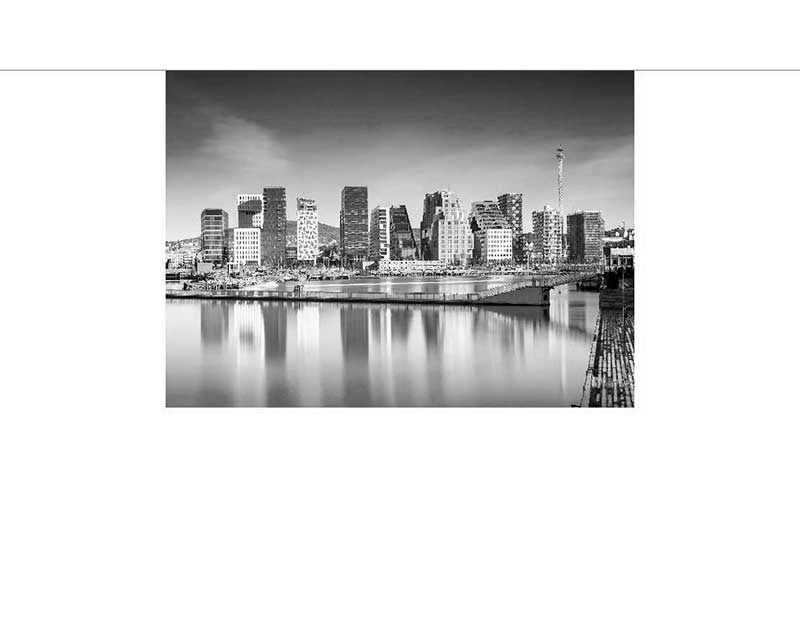 Schwarz-weiß Bild einer modernen Skyline mit hohen Gebäuden, die sich im ruhigen Wasser spiegeln