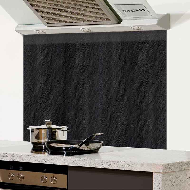 Schwarzer Spritzschutz mit Dunstabzugshaube und Töpfen auf einer Küchenarbeitsplatte