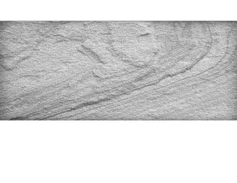 Nahaufnahme von feinem grauen Sand mit sanften, wellenartigen Linien und Texturen