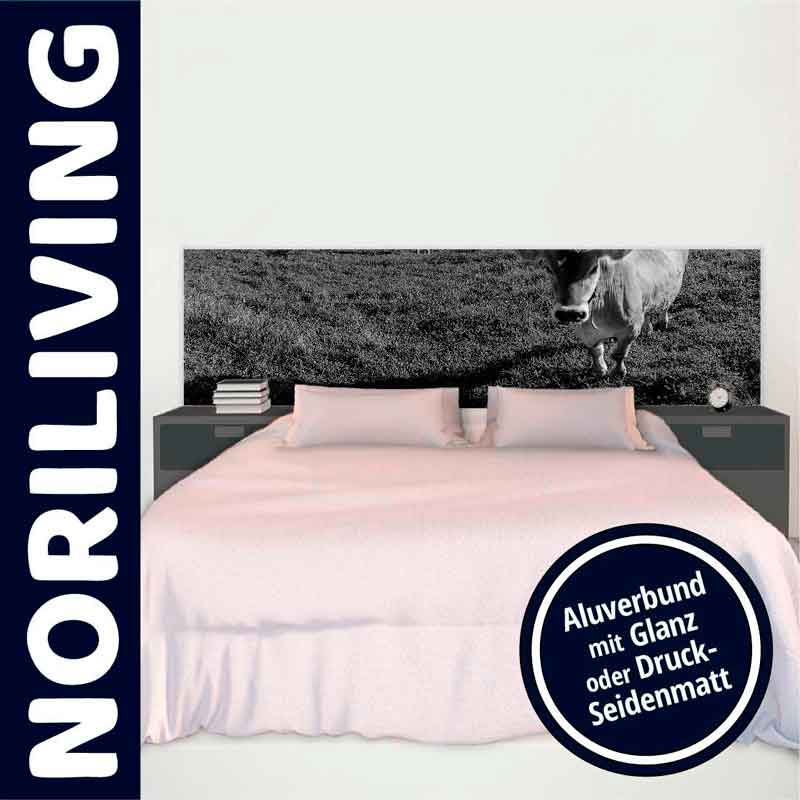 Schlafzimmer mit Doppelbett, einem Kunstbild einer Kuh auf der Wiese als Kopfteil und seitlichen Nachttischen