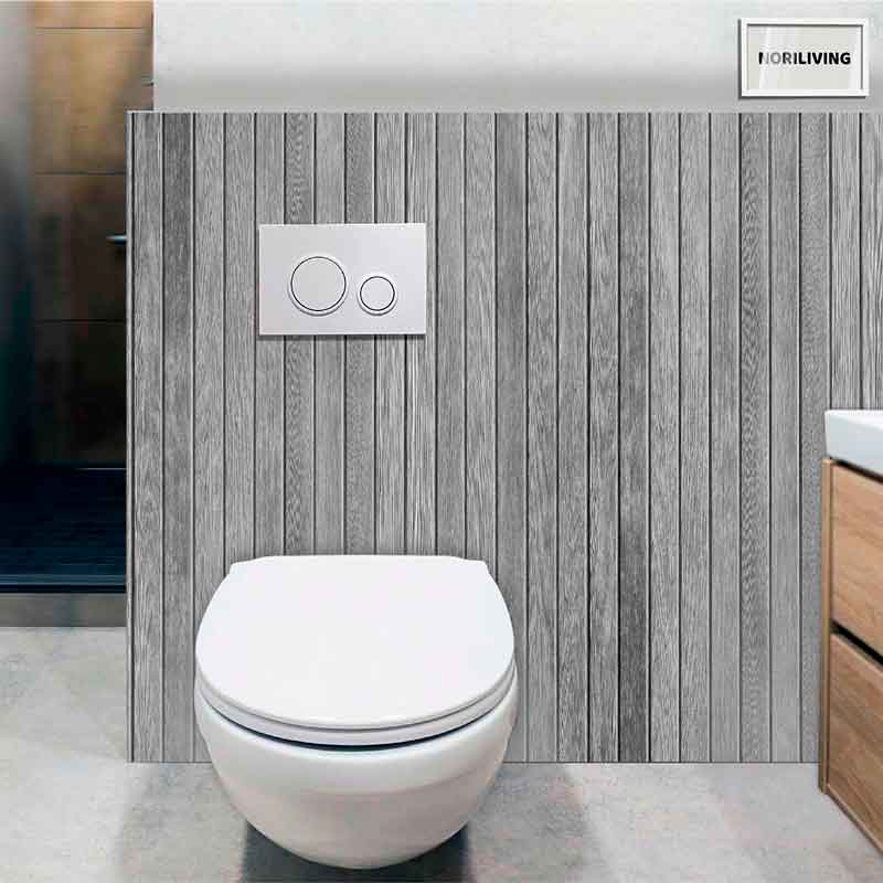 Wandhängende Toilette vor einer grauen Holzverkleidung mit spülkastenintegriertem Druckknopf